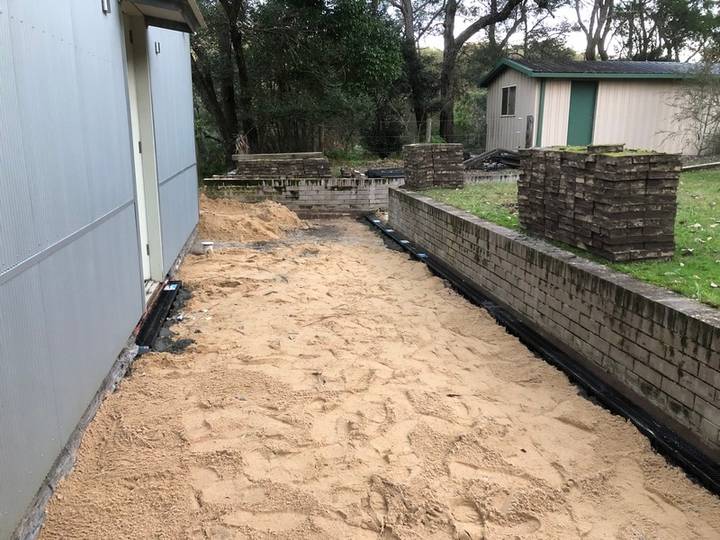 Level sand base - Allsites Excavations Sydney Compacted sand base and fill preparation beside a Sydney retaining wall