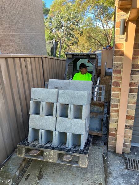 Block delivery through tight access - Allsites Excavations Sydney Retaining wall blocks moved through tight access with compact machinery in Sydney
