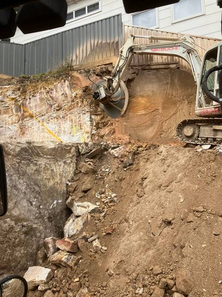 Rock face trimming - Allsites Excavations Sydney Excavator trimming sandstone rock for a tight access Sydney excavation