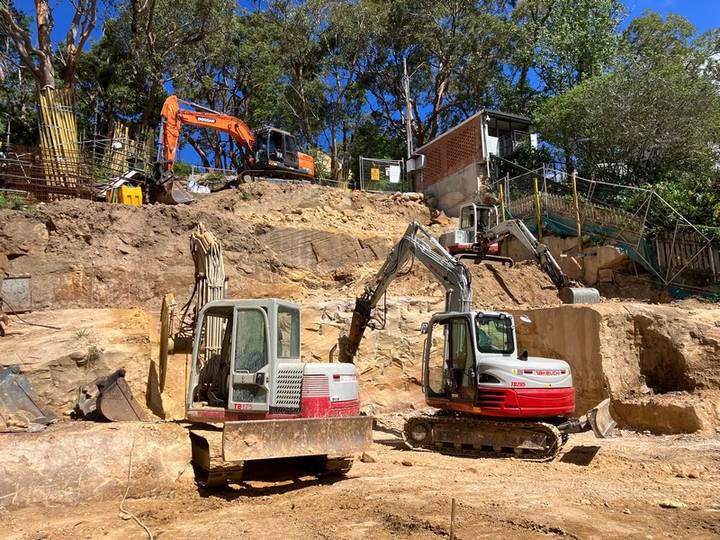 Steep rock excavation - Allsites Excavations Sydney Excavators working on steep rock excavation and retaining wall preparation in Sydney